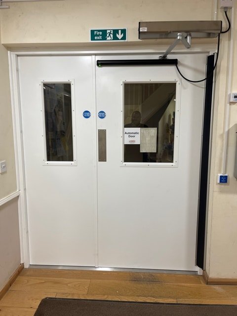 White Steel door with an automatic swing door operator