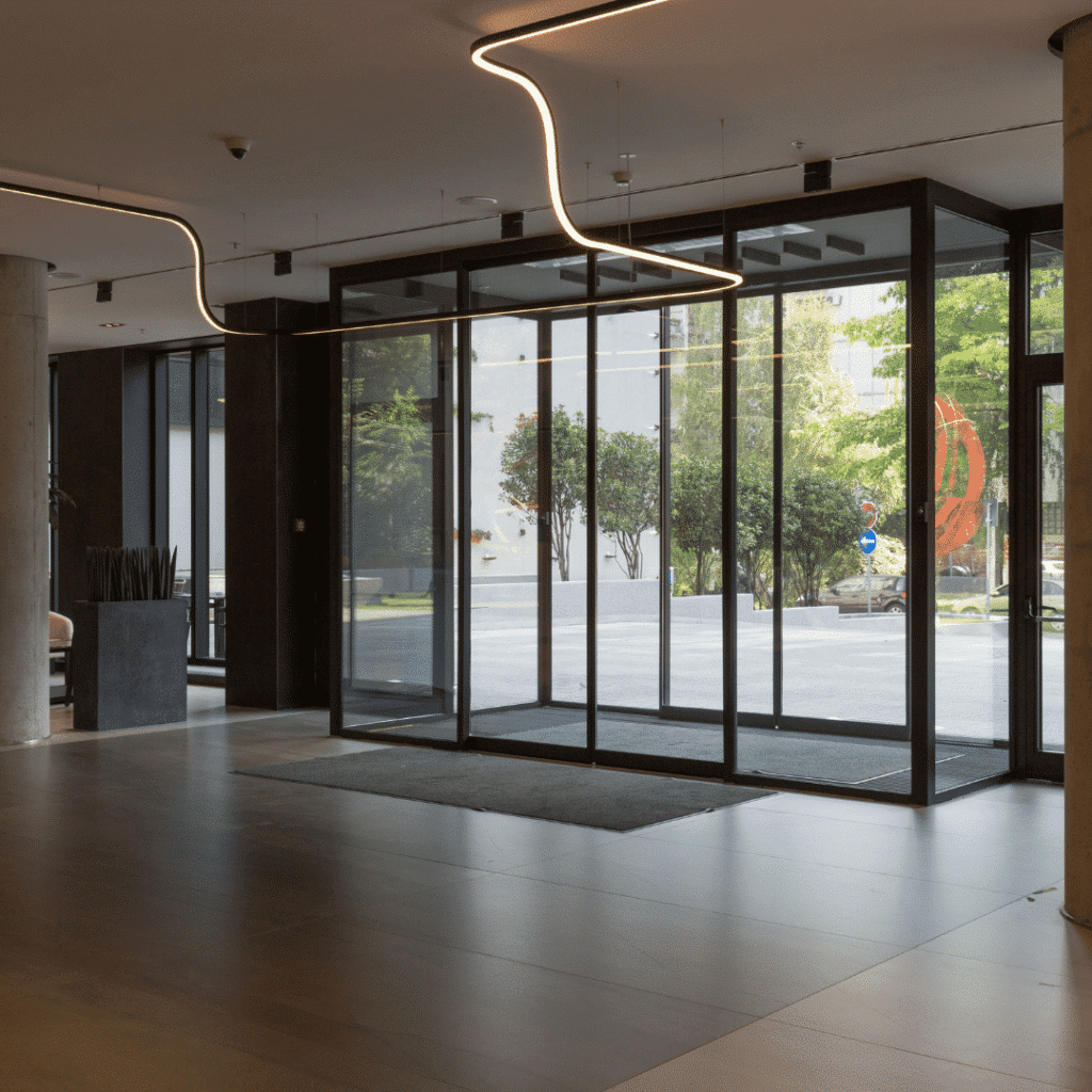 Image from inside a building of black framed automatic doors. Automatic door maintenance contracts.