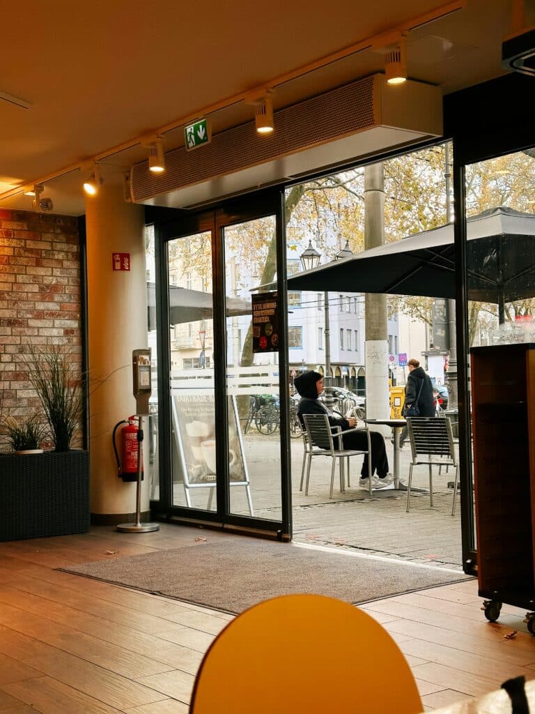 Automatic doors at cafe entrance. Energy efficiency of automatic doors - blog post by J Manny.